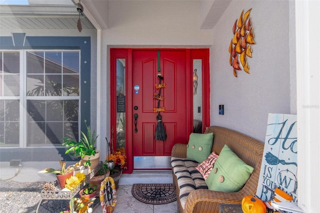 view of exterior entry featuring covered porch