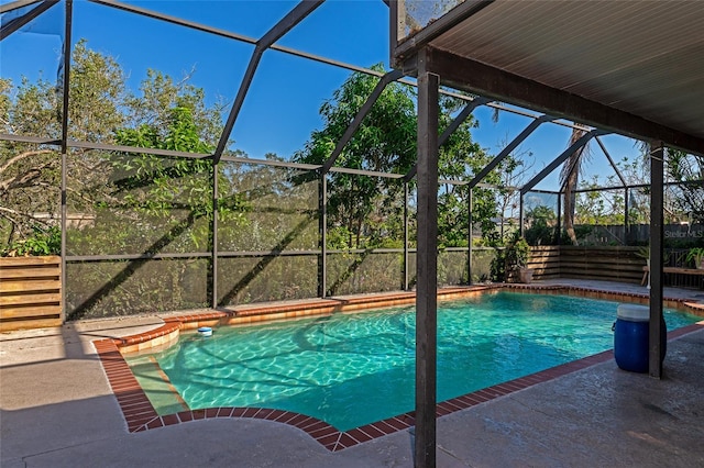 view of swimming pool featuring a patio and a lanai