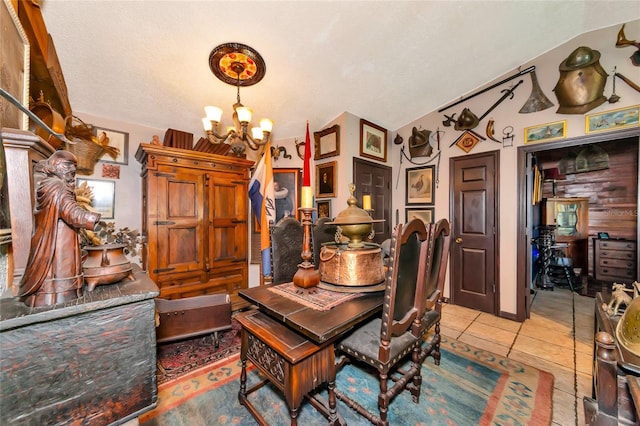 dining area featuring light tile patterned floors, a notable chandelier, a textured ceiling, and vaulted ceiling