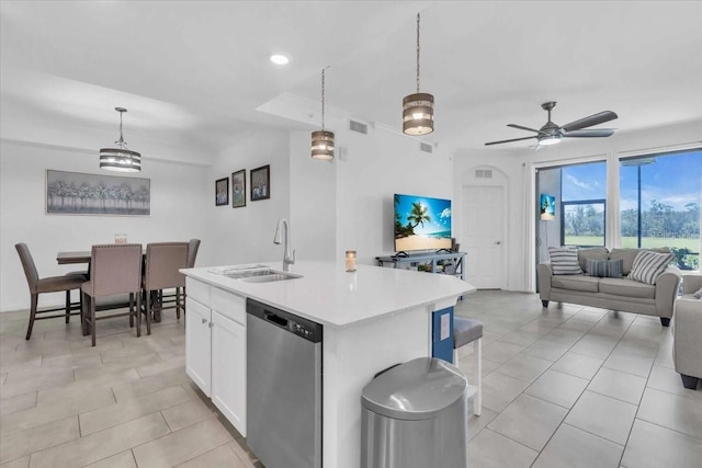 kitchen with white cabinets, dishwasher, an island with sink, and hanging light fixtures