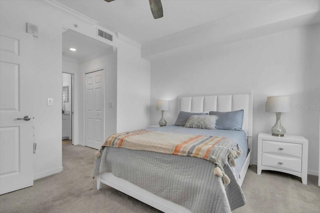 carpeted bedroom with ornamental molding and ceiling fan