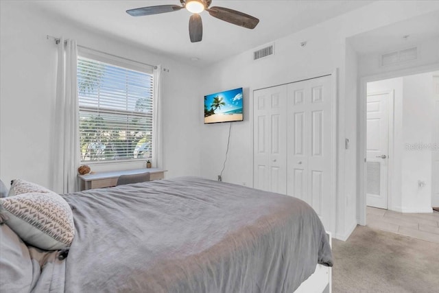 bedroom with light carpet, a closet, and ceiling fan