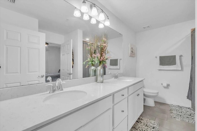 bathroom with vanity, toilet, and tile patterned flooring