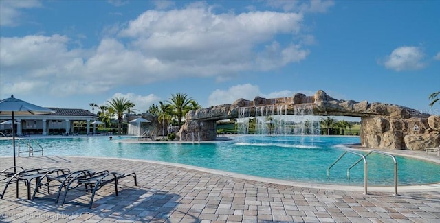 view of pool with a patio area and pool water feature