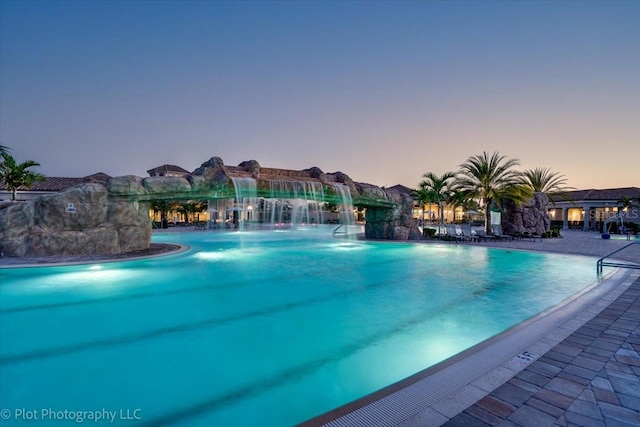 pool at dusk with pool water feature