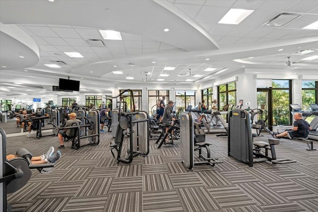 gym featuring carpet and a paneled ceiling