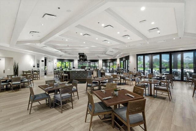 dining area with light hardwood / wood-style floors, beam ceiling, and coffered ceiling