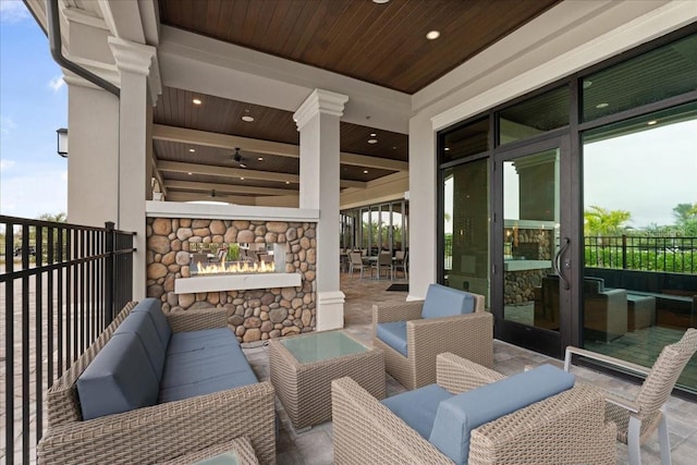 view of patio / terrace with an outdoor living space with a fireplace