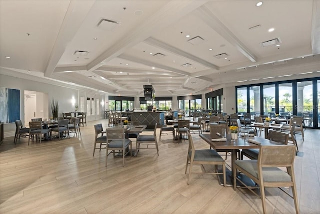 dining space featuring french doors, light hardwood / wood-style floors, and beam ceiling