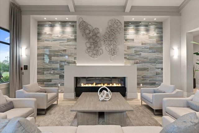 living room featuring beamed ceiling and light hardwood / wood-style flooring