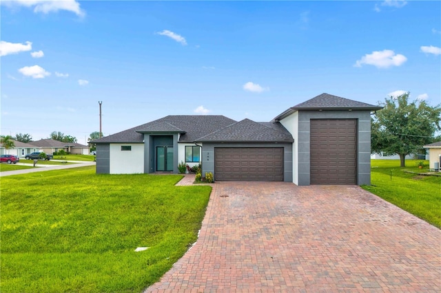 view of front of property with a front lawn and a garage