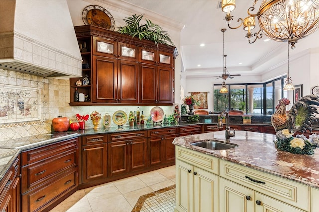 kitchen with cream cabinets, premium range hood, electric cooktop, a sink, and ornamental molding