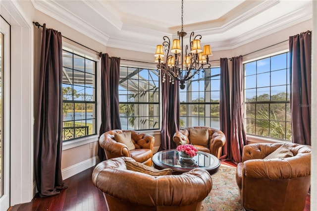 sunroom with a tray ceiling and a notable chandelier