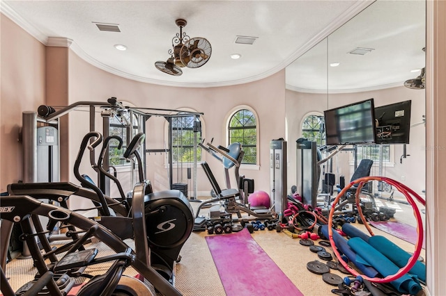 workout area with visible vents and ornamental molding