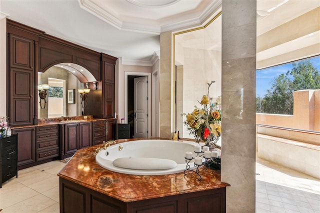 bathroom featuring a jetted tub, tile patterned flooring, crown molding, and vanity