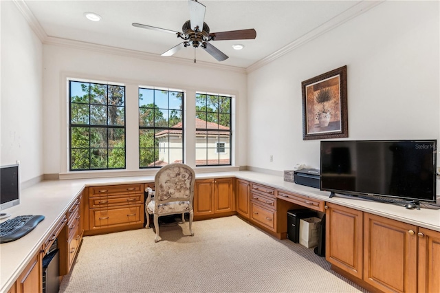 home office with light carpet, a ceiling fan, crown molding, and built in study area