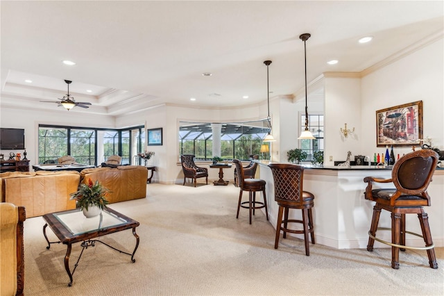 interior space featuring a kitchen breakfast bar, recessed lighting, light colored carpet, and crown molding