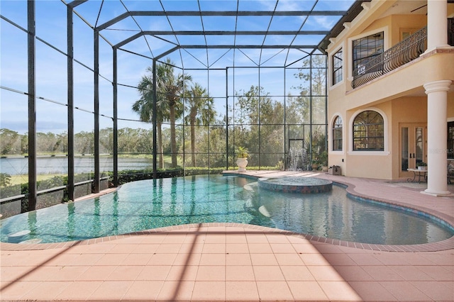 view of swimming pool with a patio area, a pool with connected hot tub, glass enclosure, and french doors