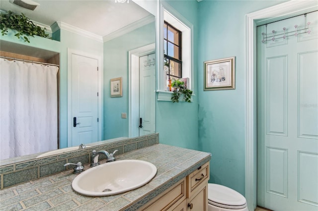 bathroom featuring crown molding, vanity, and toilet