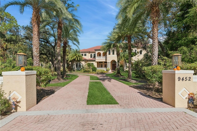 mediterranean / spanish-style house with a balcony and stucco siding