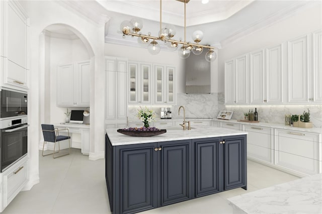 kitchen featuring decorative backsplash, oven, and white cabinets