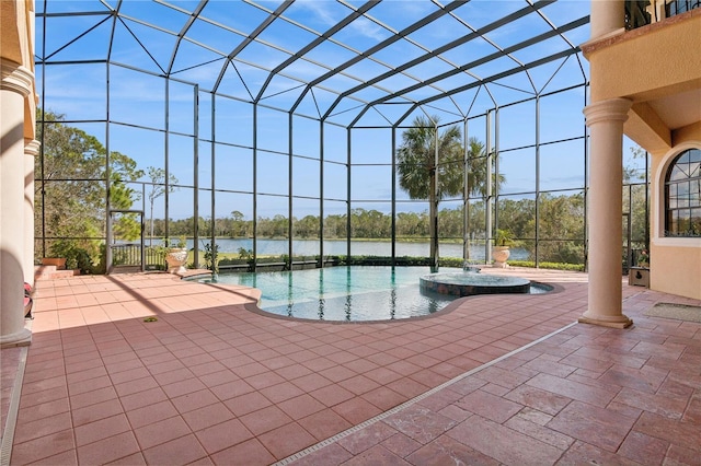 view of swimming pool with a patio area, a lanai, and a pool with connected hot tub