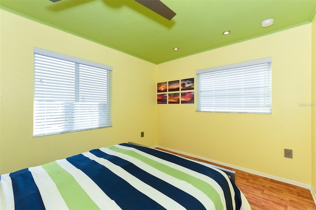 bedroom featuring hardwood / wood-style flooring and ceiling fan