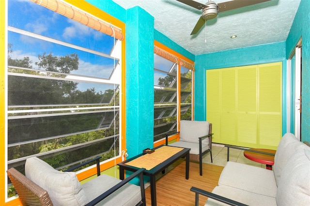 sunroom featuring ceiling fan