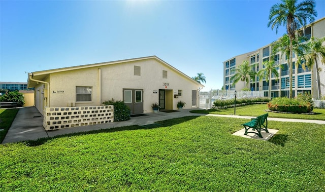 rear view of house with a lawn