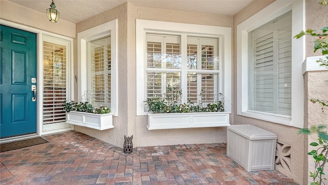 view of exterior entry featuring a porch