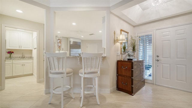 foyer featuring light tile patterned flooring, recessed lighting, and baseboards