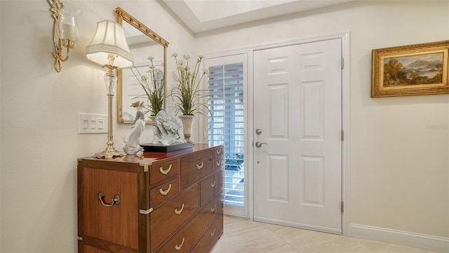 foyer entrance with light tile patterned floors