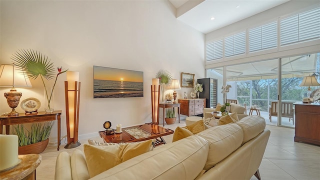 living area featuring light tile patterned floors and a high ceiling