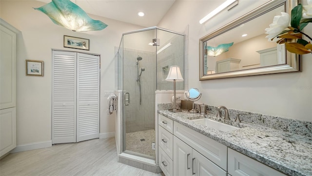 bathroom featuring vanity and an enclosed shower