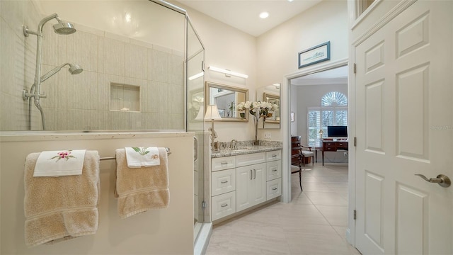 bathroom with recessed lighting, walk in shower, tile patterned flooring, and vanity