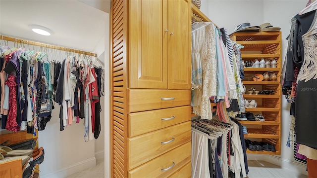 spacious closet with light tile patterned floors