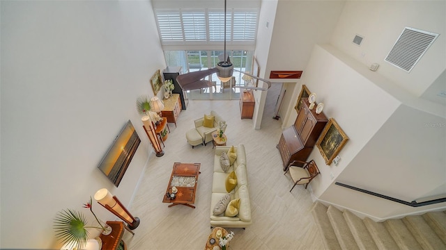 living room featuring light carpet and a high ceiling