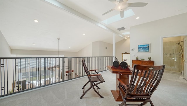 interior space with vaulted ceiling with skylight, light colored carpet, ceiling fan, visible vents, and recessed lighting