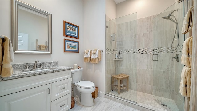 bathroom featuring vanity, walk in shower, and toilet