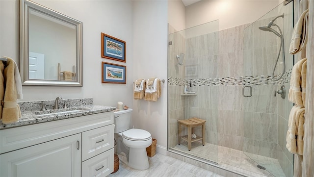 full bathroom with toilet, vanity, and a shower stall