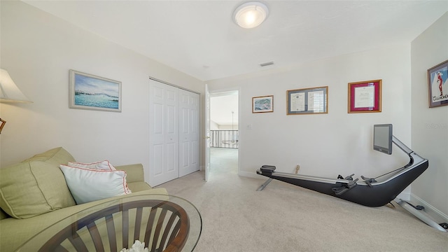 workout room with light colored carpet