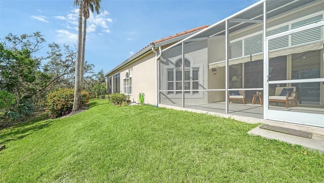 exterior space featuring stucco siding, a tiled roof, and a lawn