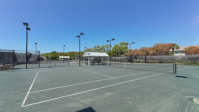 view of sport court featuring fence