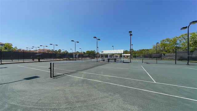 view of sport court featuring fence