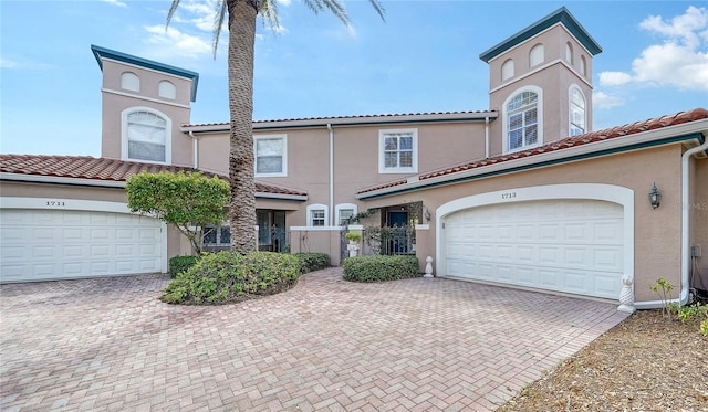 1713 Starling Dr Unit 1713, Sarasota, FL 34231 - view of front of property with stucco siding, a tile roof, and decorative driveway