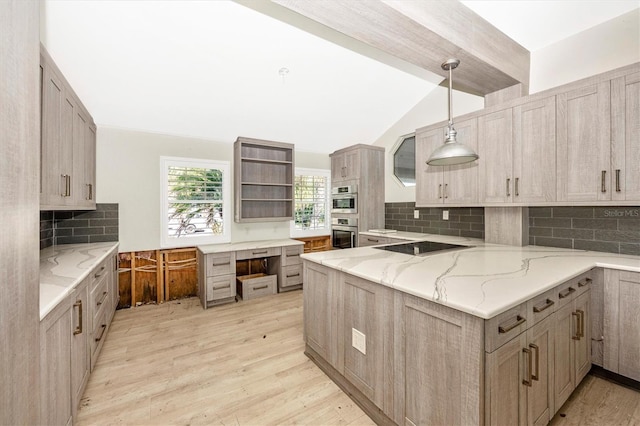 kitchen with backsplash, light stone counters, light hardwood / wood-style flooring, and decorative light fixtures