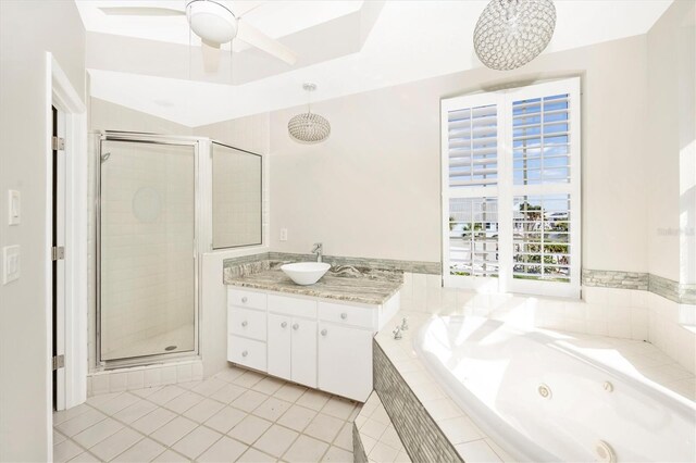 bathroom featuring tile patterned flooring, vanity, ceiling fan, and plus walk in shower