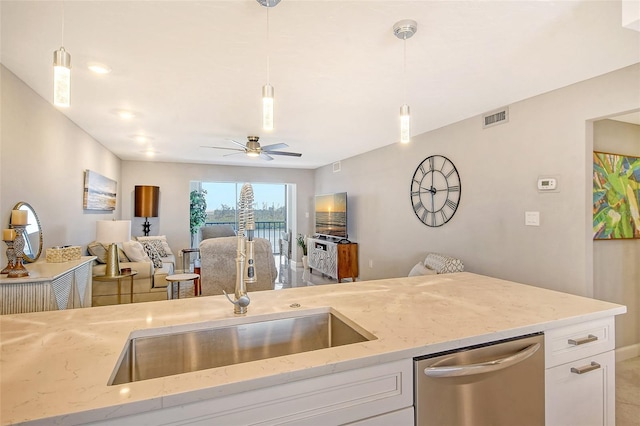 kitchen with dishwasher, light stone countertops, and hanging light fixtures