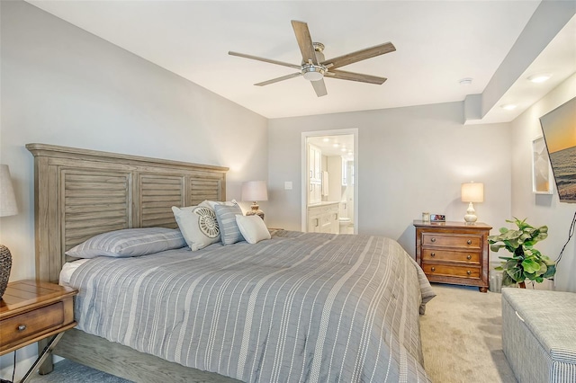 carpeted bedroom featuring connected bathroom and ceiling fan