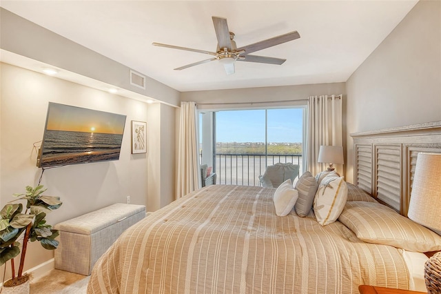 bedroom featuring access to exterior, light colored carpet, and ceiling fan